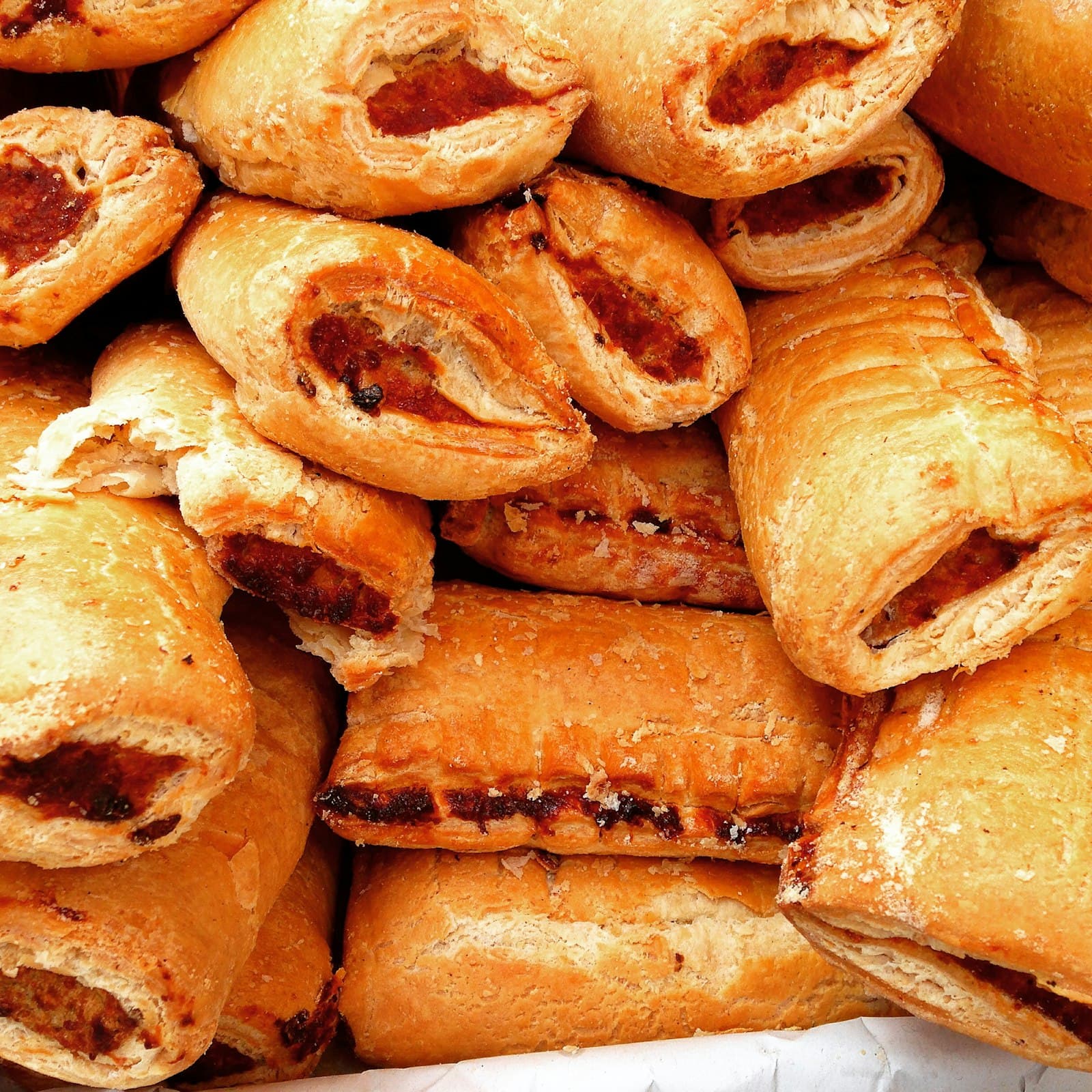 A pile of puff pastries with a red guava filling