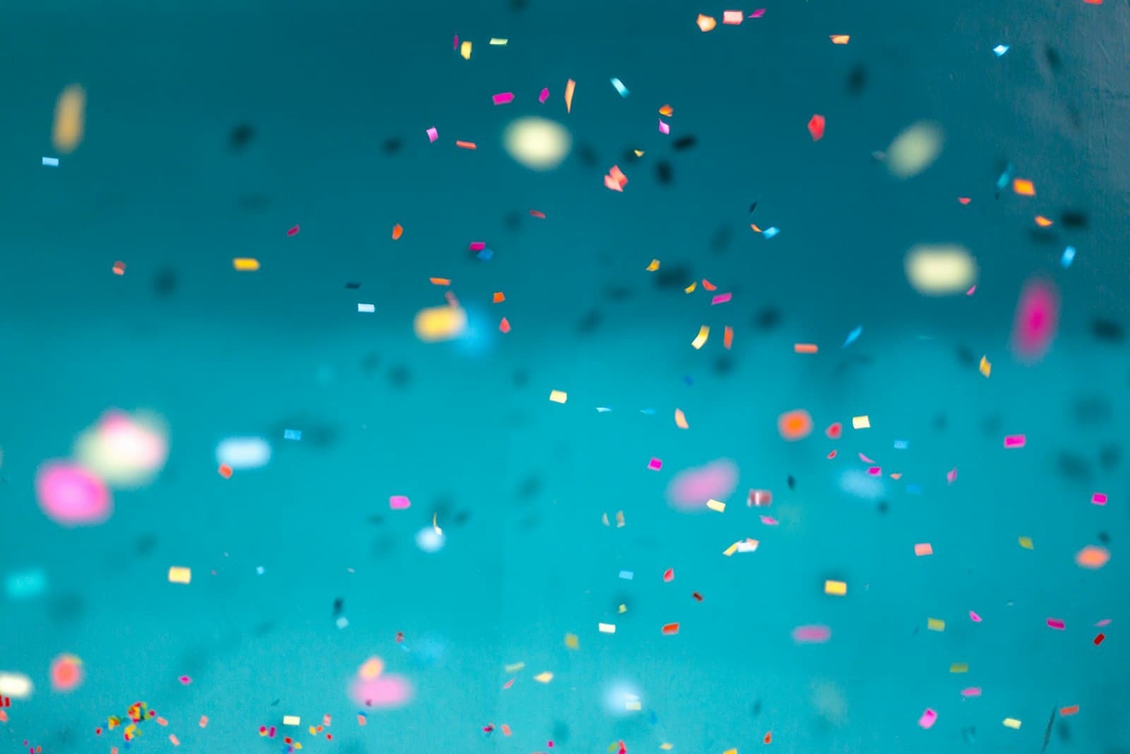 Confetti scattered against an open sky
