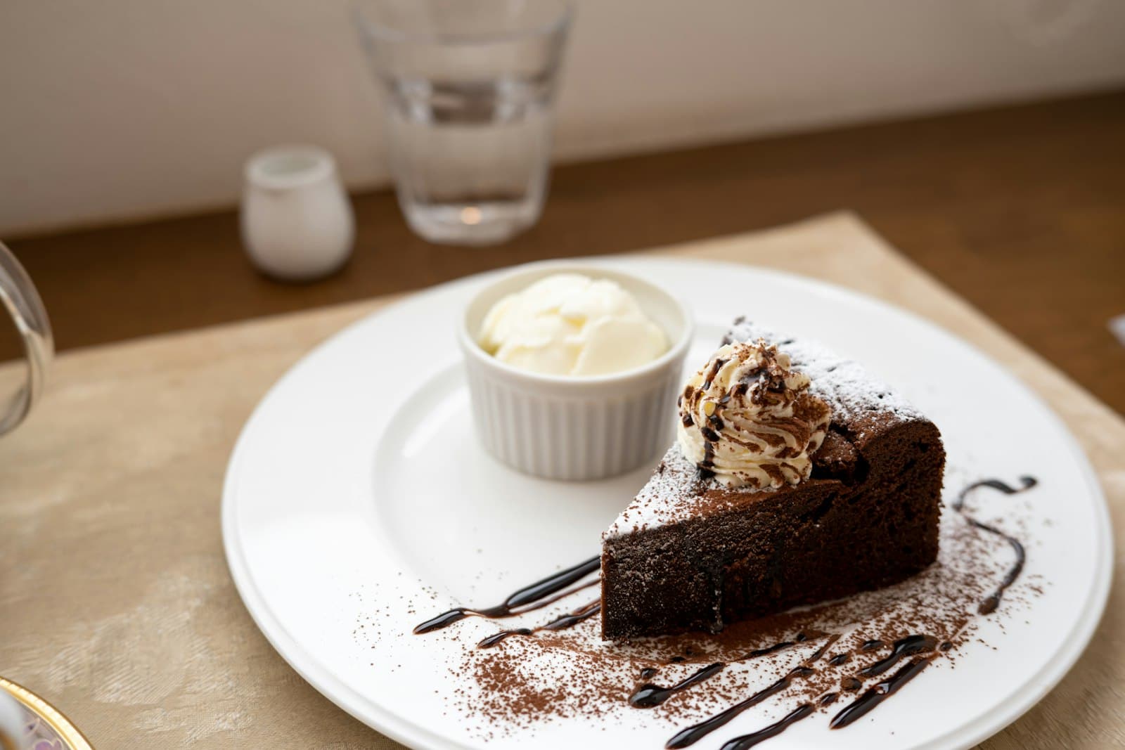 A slice of chocolate cake on a white plate