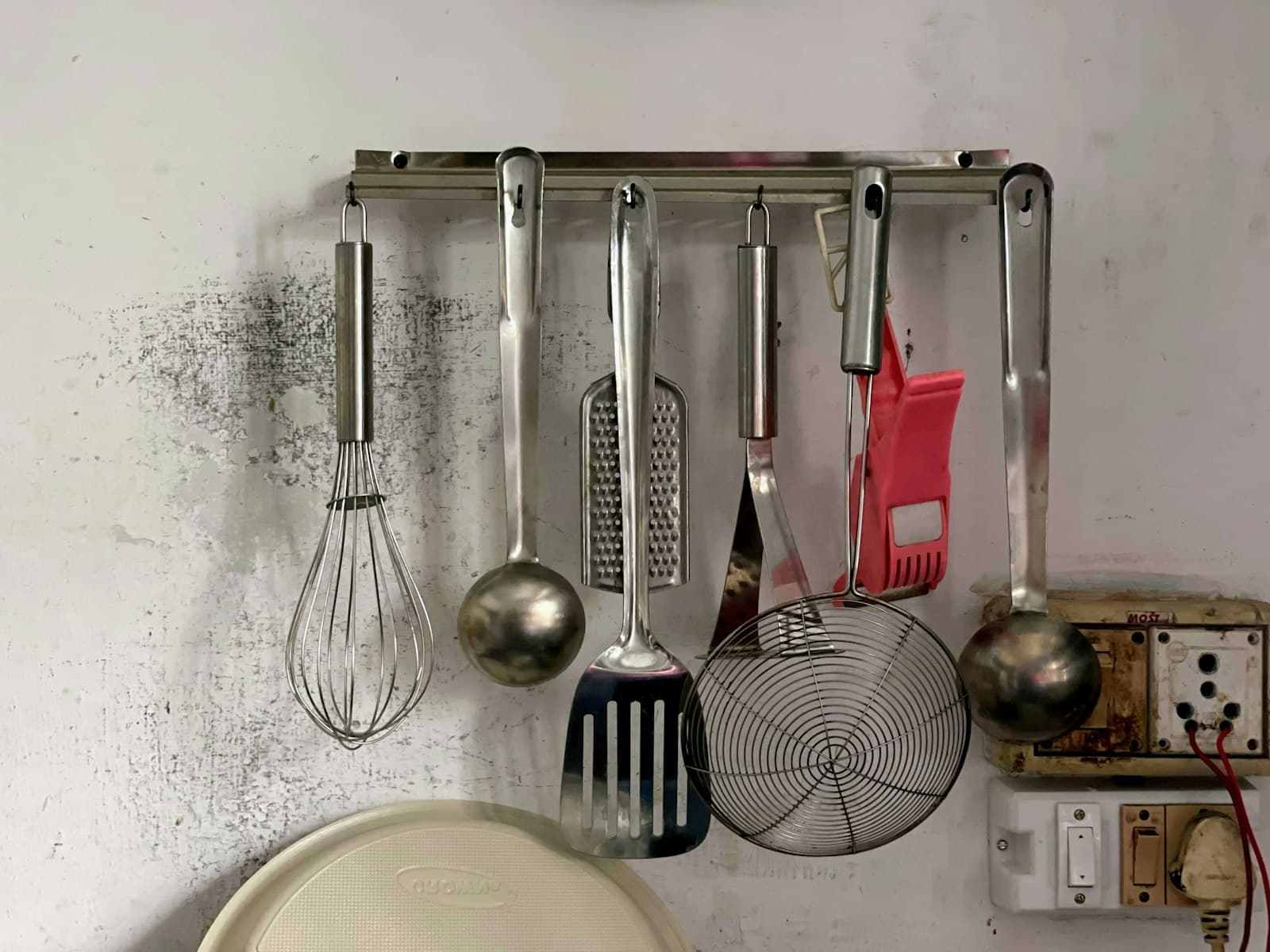 Kitchen utensils hanging on a rail