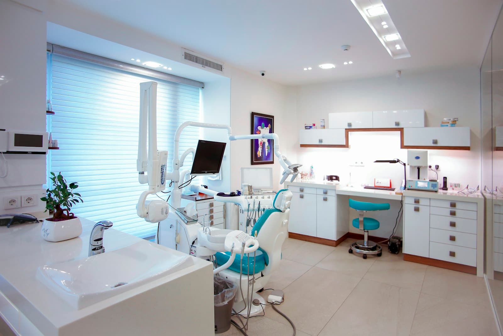 Bright, modern treatment room at Brightside Dental with a teal patient chair