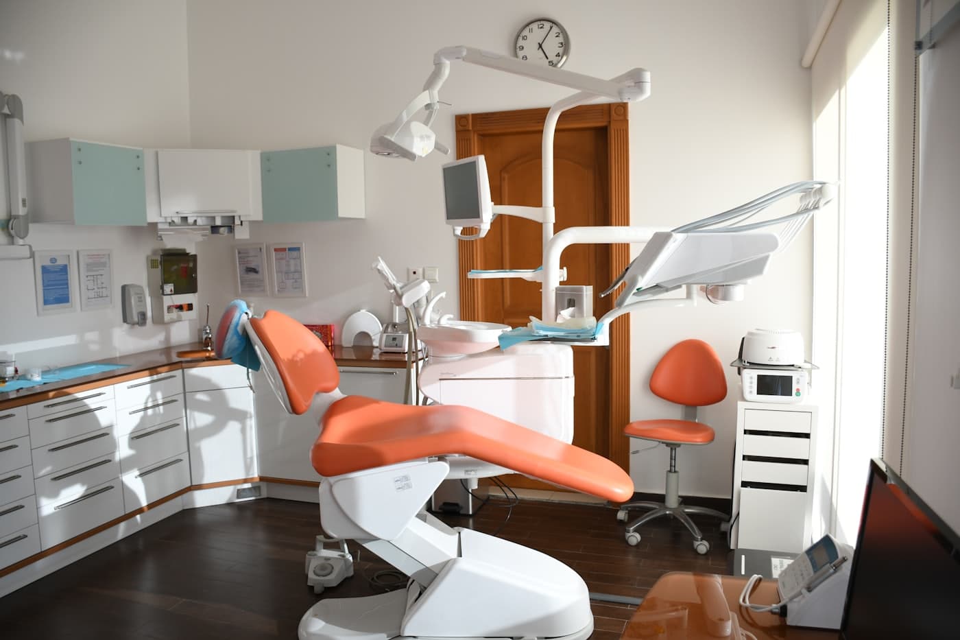 Sunlit treatment room with a coral patient chair
