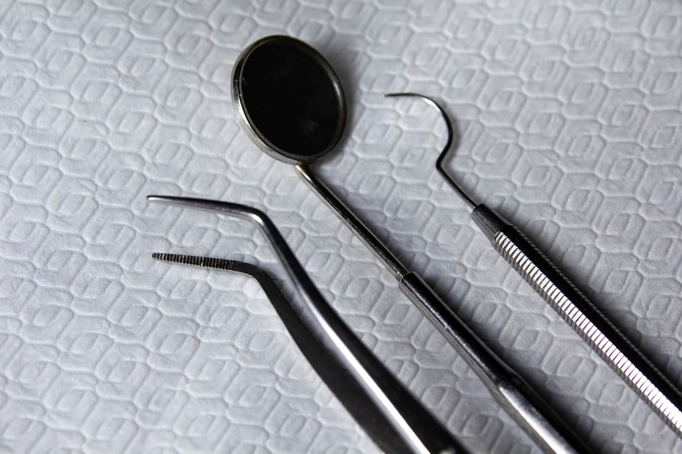 Clean dental instruments laid out on a fresh tray liner