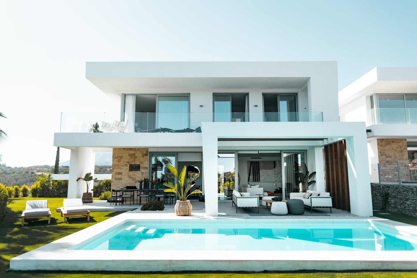 White modern villa with a covered terrace and pool