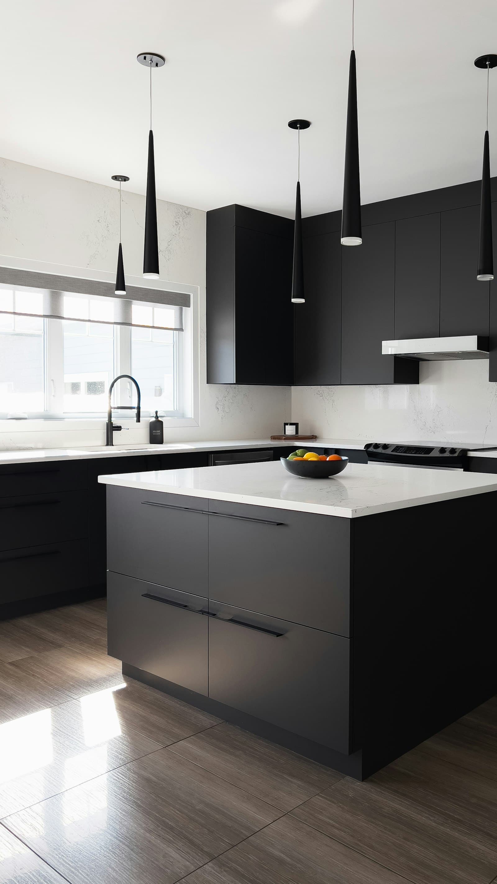 A finished kitchen with dark cabinetry and a stone island