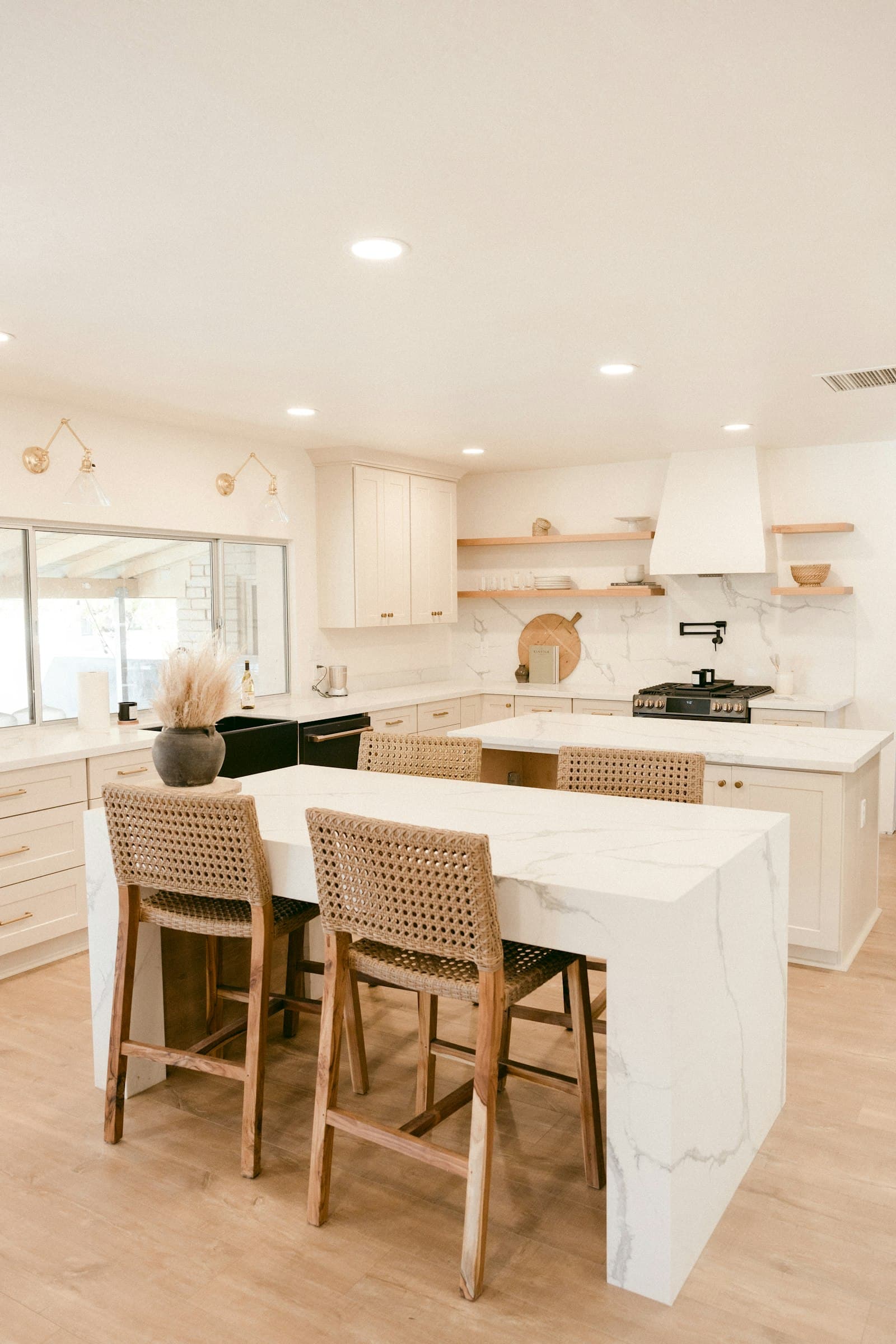 A white kitchen with an island and counter seating