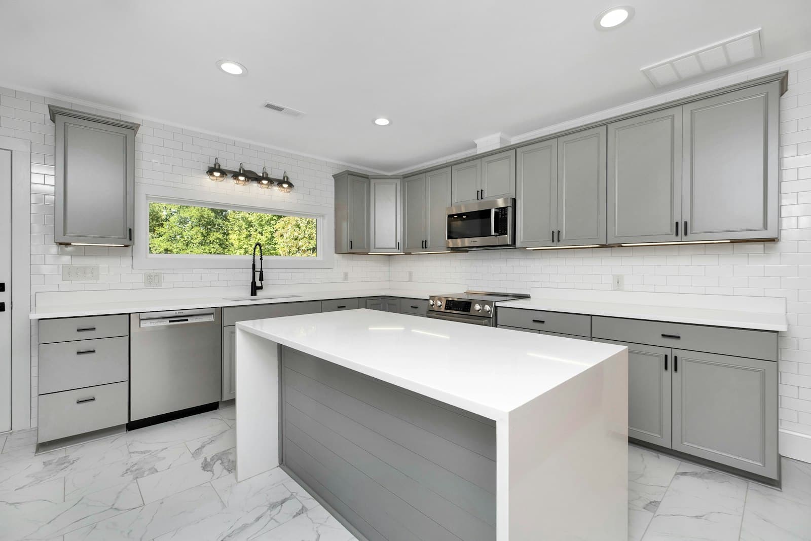 A grey kitchen with a waterfall-edge island