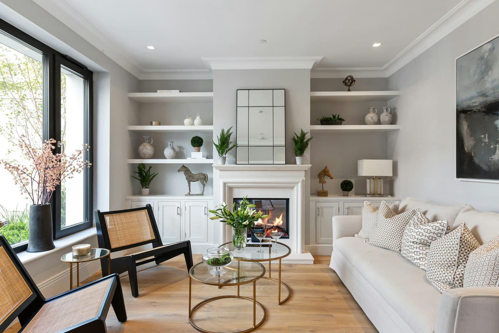 A living room with built-in shelving beside a fireplace