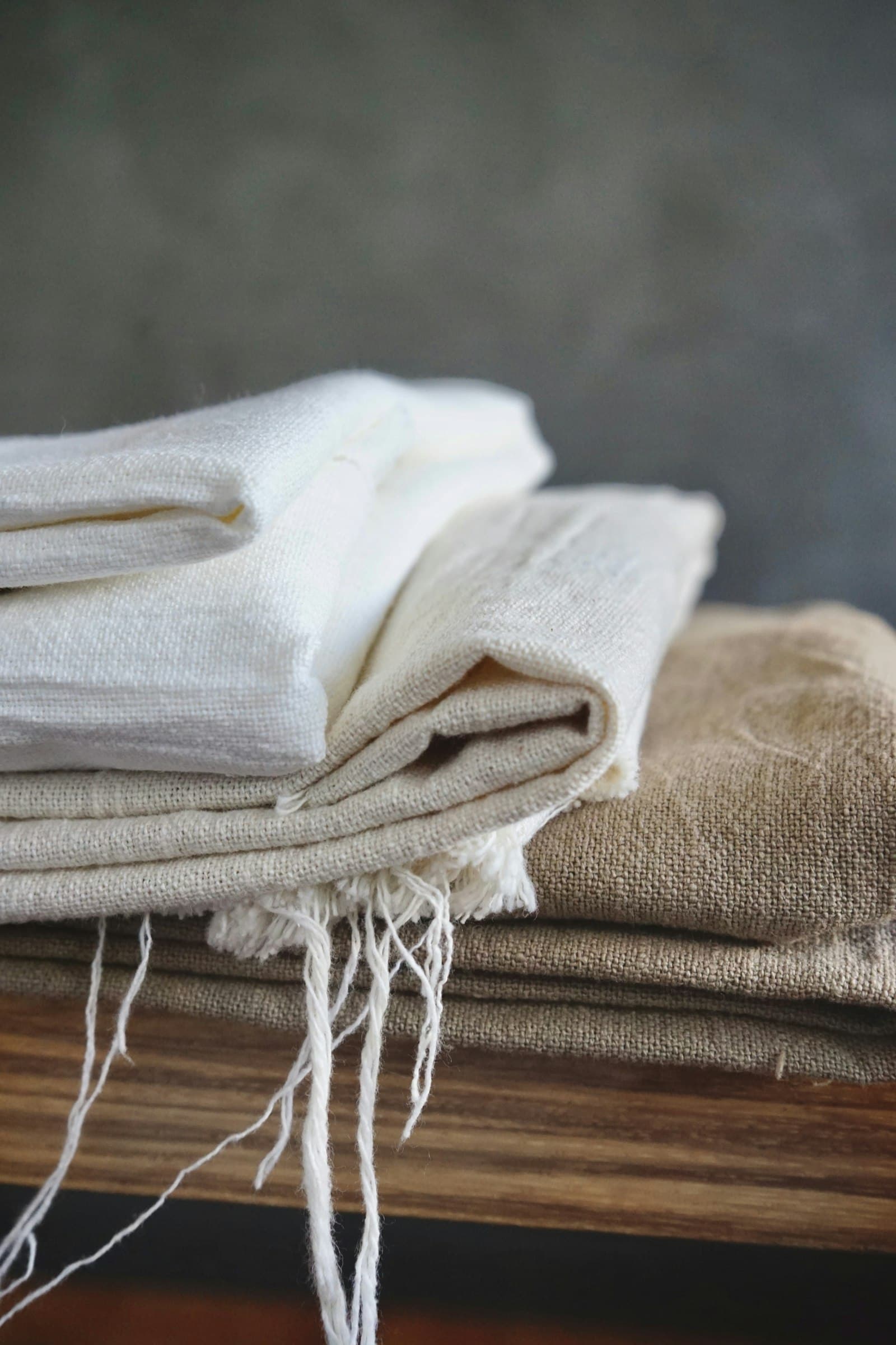 A stack of folded natural-fibre textiles